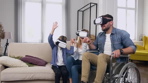 Modern Family which Enjoying Futuristic Entertaintment Using Virtual Reality Headset at Home