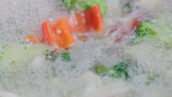 Foam Appearing in Boiling Cauliflower Broccoli and Red Bell Peper  Closeup