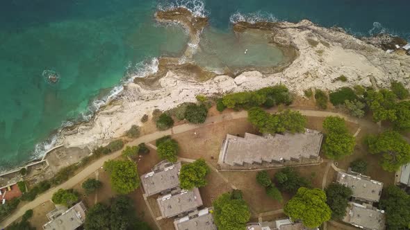 Apartments, Bungalos, Rocks And Sea. Aerial Footage