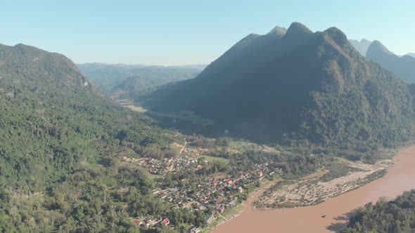 Aerial: flying over Muang Ngoi village Nam Ou River Nong Khiaw Laos