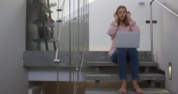 Caucasian woman using laptop in hotel