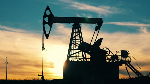 Fast Motion of a Pumpjack Extracting Oil at Sunset. Crude Oil, Gas, Petroleum Prices Concept.