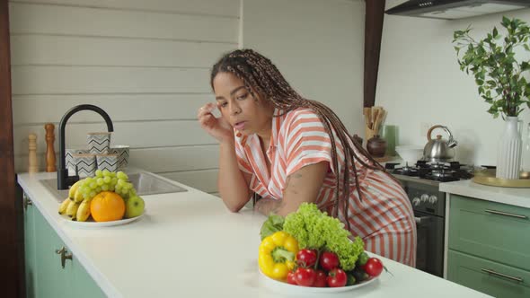 Portrait of Young Black Woman Feeling Sad and Bored with Diet at Home