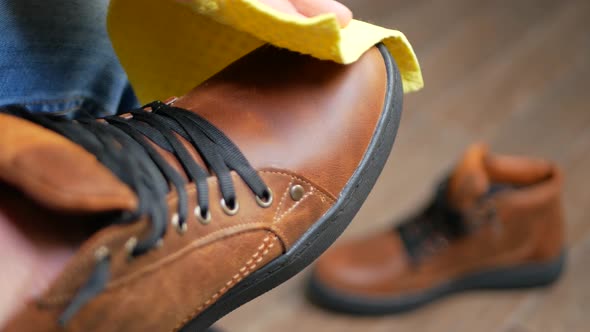 Hand Dusting Brown Leather Shoes with Yellow Rag