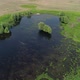Aerial View of a Flock of Birds Takes Off From a Small Lake in the Middle of a Green Meadow - VideoHive Item for Sale