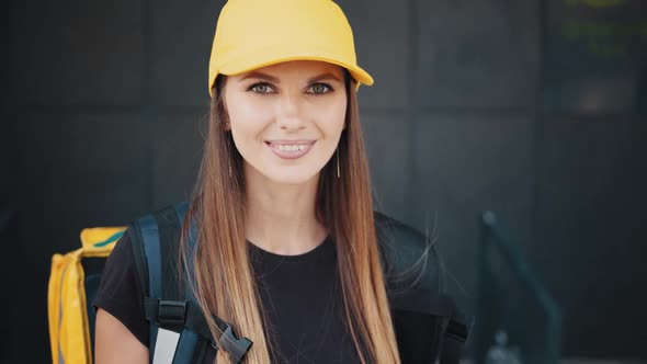 Portrait Young Woman in Black Shirt Delivering Food Using Gadgets to Track Order