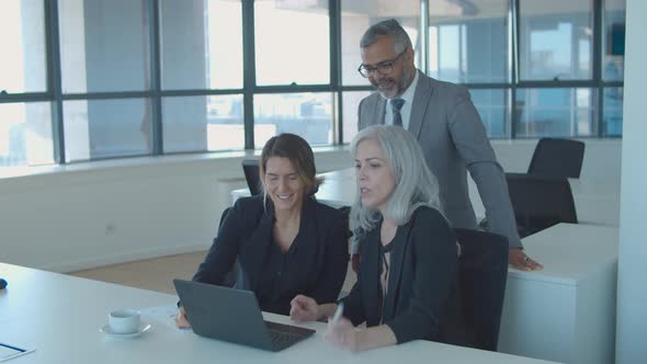 Group of Businesspeople Using Laptop for Video Talk