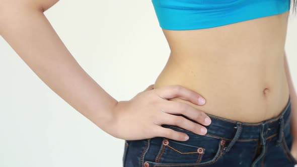 close up waist of woman in blue jeans