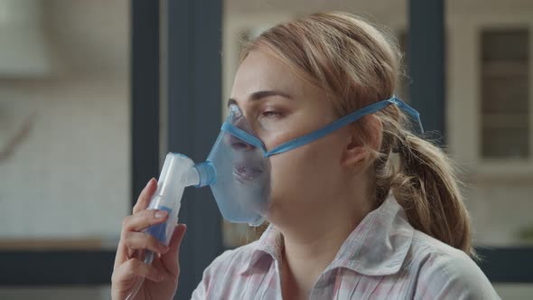 Woman Using Nebulizer for Respiratory Diseases Indoor