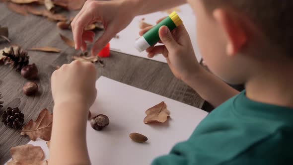 Mother and Son Making Pictures of Autumn Leaves