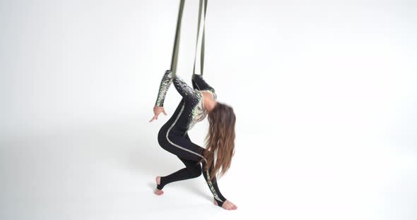 Aerial Silks Performance in the Studio By a Young Brunette Woman Gymnastics