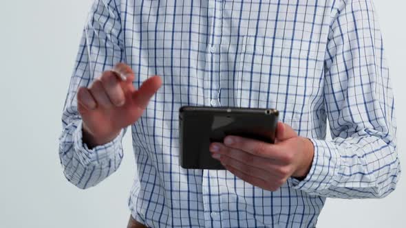 Portrait of smiling man using digital tablet