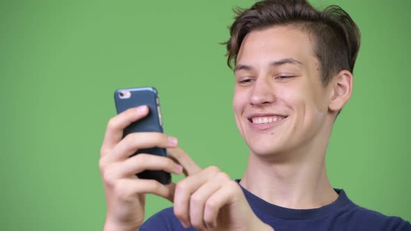 Young Handsome Teenage Boy Using Phone