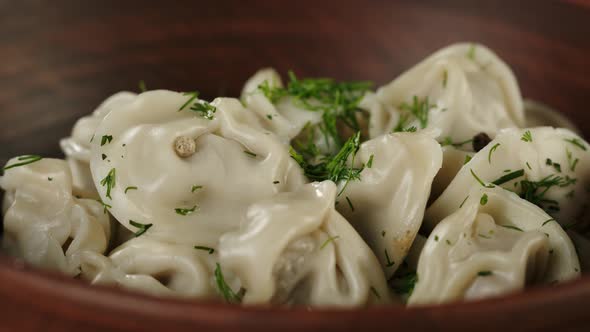 Sprinkling Greenery Dill on Boiled Dumplings Closeup Cooking Dough Products with Meat