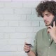 Guy Talking on Phone and Reading Credit Card Number While Working - VideoHive Item for Sale