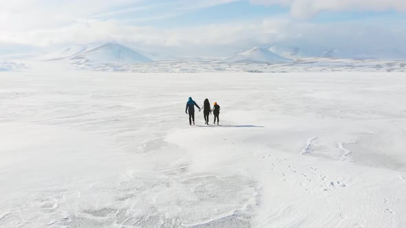 Slow Motion Three Person Family Walks On Frozen Lake