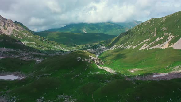 Aerial View of Valley Among Beautiful Mountains of Caucasus, Stunning Gorge Covered with Green Grass