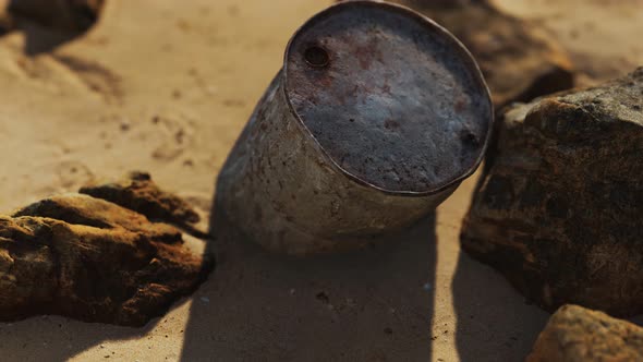 Rusty Metal Oil Barrel on Sand Beach