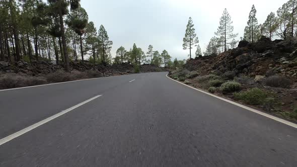 Long asphalt road ground view with sunset light and travel concept - mountain and sky