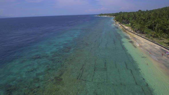 Backward flying over the coastline of the island Nusa Penida, Indonesia.