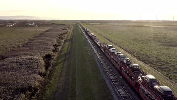 Moto Rail Train Carrying Vehicles and Passengers on a Journey