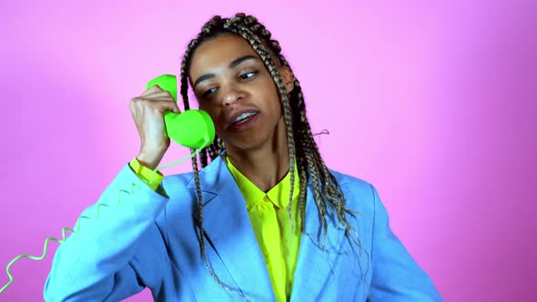 Woman with braids acting on a colored background