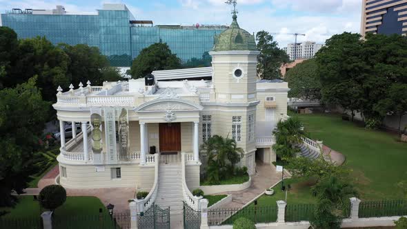 Aerial push in and pitch down showing the Casa Museo Quinta Montes Molina on the Paseo Montejo in Me