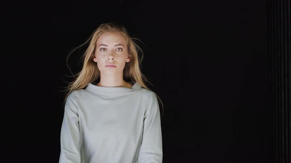 Portrait of beautiful blonde woman, hair blowing in wind