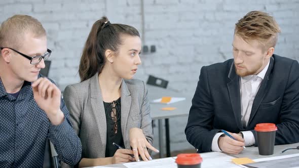 Woman and Man Making Brainstorming Research in Office