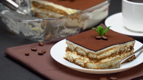 Portion of Traditional Italian Tiramisu Dessert Cup of Espresso and Baking Dish