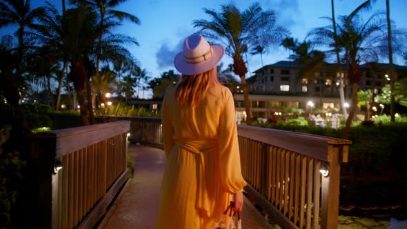 Elegant Traveler Woman in Yellow Dress at Luxury Resort Tourists SPA Hotel