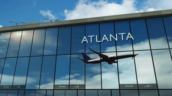 Airplane landing at Atlanta mirrored in terminal