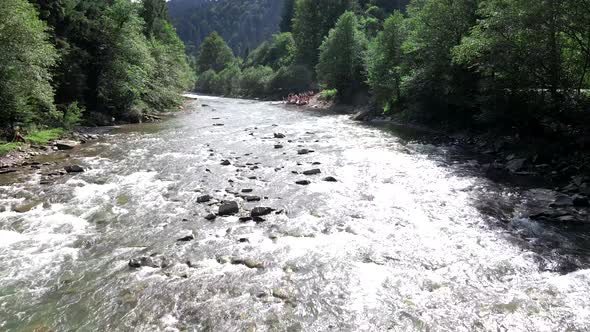 People Rafting at Mountain River Summer Sunny Day