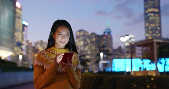 Woman look at mobile phone in city