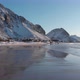 Ramberg beach during winter covered by snow in the Lofoten. Mountains reflection in the water. - VideoHive Item for Sale