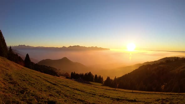 Timelapse of the Sun setting over mist covering Lake Léman - Switzerland. "Le Folly" Vaud - Switzerl