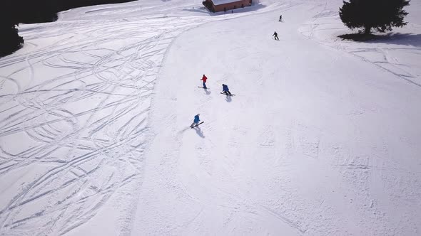 People skiing and snowboarding on snow slope in winter ski resort. Ski elevator on snow mountain. Wi