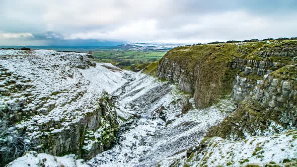 Looking down Mousegill as a snow shower approaches in the upper Eden Valley in Cumbria UK.