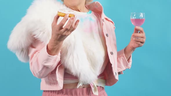 Positive Laughing Old Woman in Trendy Casual Clothes Eating Pastry