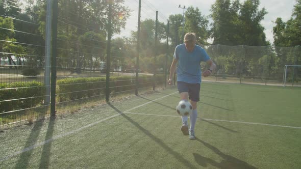 Footballer Practicing Ball Control and Coordination on Sports Field