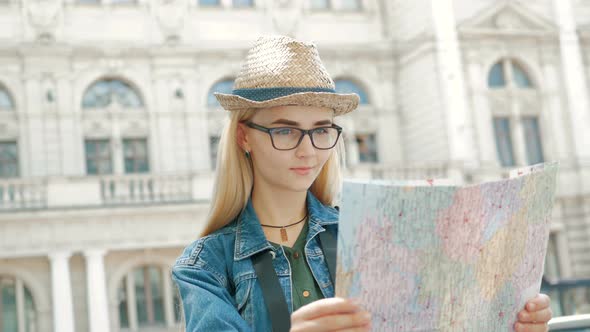 Young tourist woman exploring city map of lviv while traveling in Ukraine, vacation concept