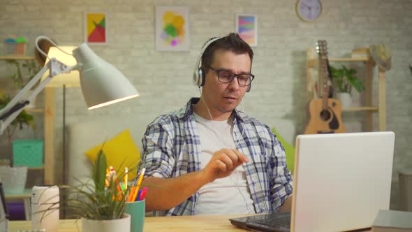 Portrait of a Man in Headphones Enjoying Music