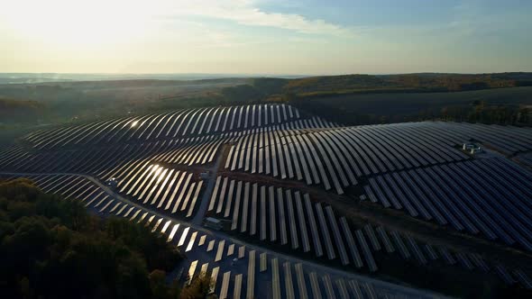 Aerial Drone Footage. Flight Over Solar Panel Farm at Sunset Autumn Season.