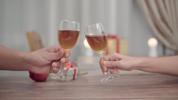 Close up romantic couple clink champagne or wine toast in a dinner at restaurant