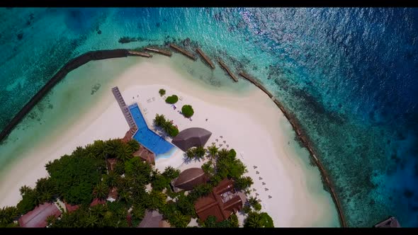 Aerial drone shot landscape of luxury seashore beach voyage by turquoise sea with white sand backgro