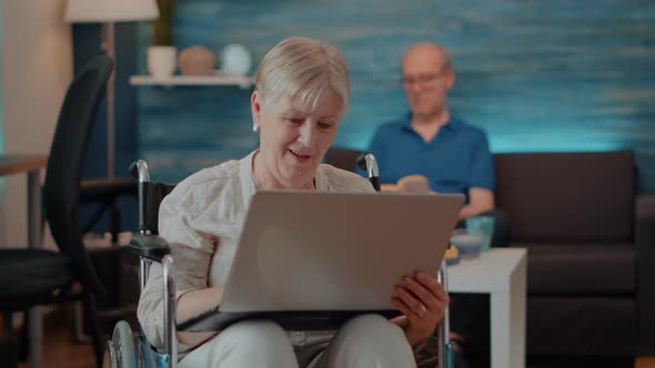 Senior Adult with Chronic Disability Using Laptop Computer