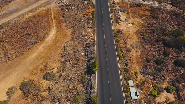 Top View of a Car Rides Along a Desert Road on Tenerife Canary Islands Spain