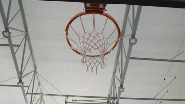 African american male basketball player scoring goal during match