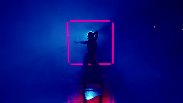 Silhouette of Woman Dancing on Glowing Square of Led Red Lamps Background