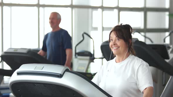 Senior Woman Running on Treadmill.